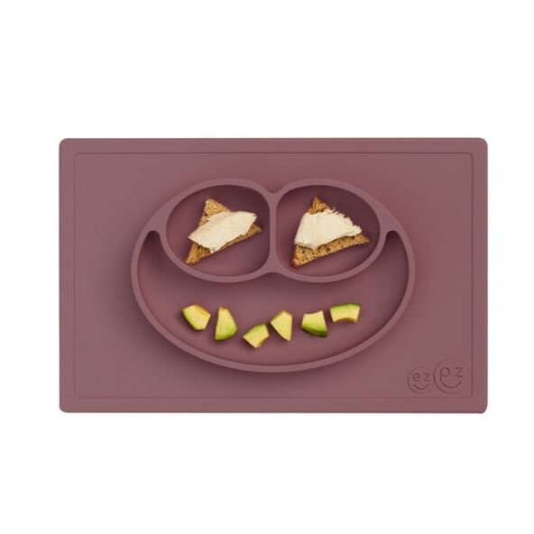 Το Happy Mat είναι το πρώτο και βραβευμένο σκεύος φαγητού της Ezpz! Η φατσούλα χωρίζει τα φαγητά σε τρία χωρίσματα, έτσι το φαγητό δεν ανακατεύεται και δεν ακουμπάει η μία τροφή την άλλη, έτσι  νιώθουν περισσότερο ανεξάρτητοι και έτοιμοι να για νέες δοκιμές! Και η μανούλα μπορεί να βάλει σ