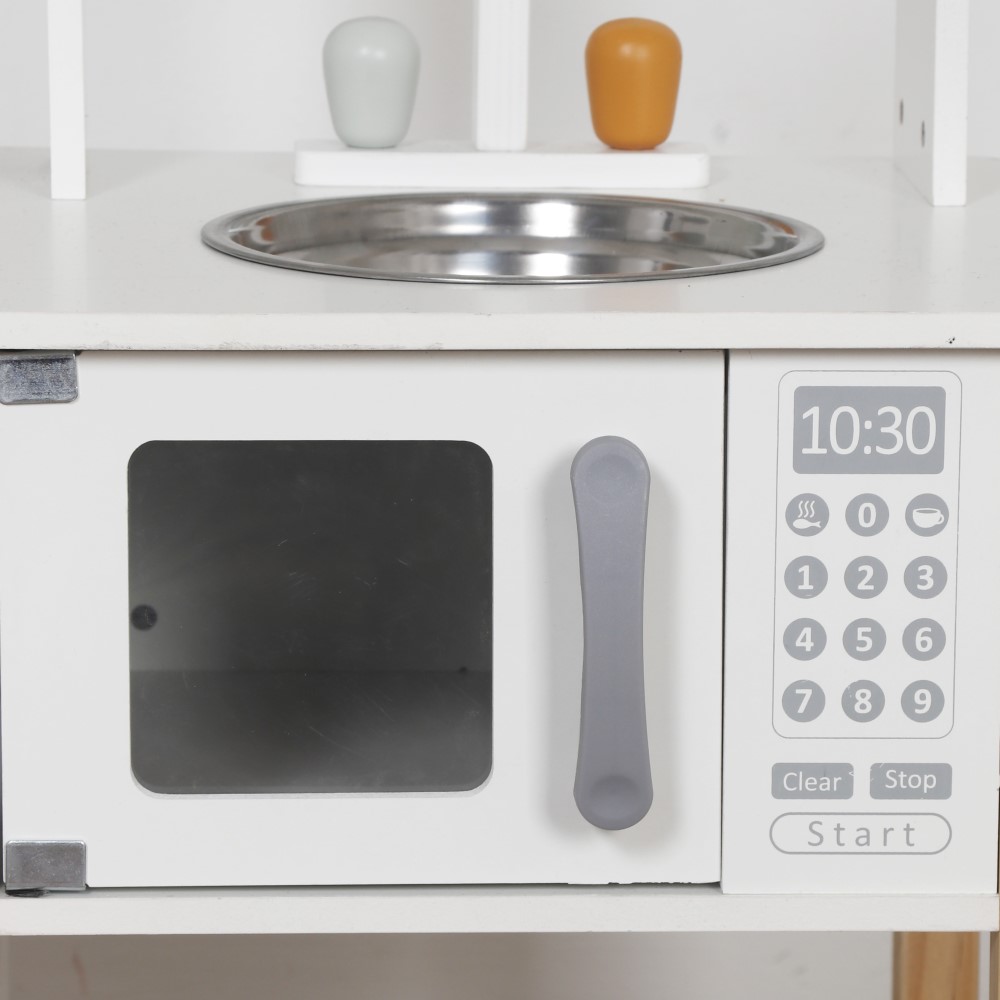 Η φωτογραφία δείχνει Η ξύλινη παιδική κουζίνα Nana της Moni Toys είναι η ιδανική επιλογή για μικρούς σεφ που λατρεύουν τα παιχνίδια ρόλων και τις γαστρονομικές περιπέτειες! Συνδυάζοντας κομψό σχεδιασμό, ρεαλιστικές λεπτομέρειες και ποιοτική κατασκευή, προσφέρει ώρες δημιουργικής και ευφάνταστης διασ